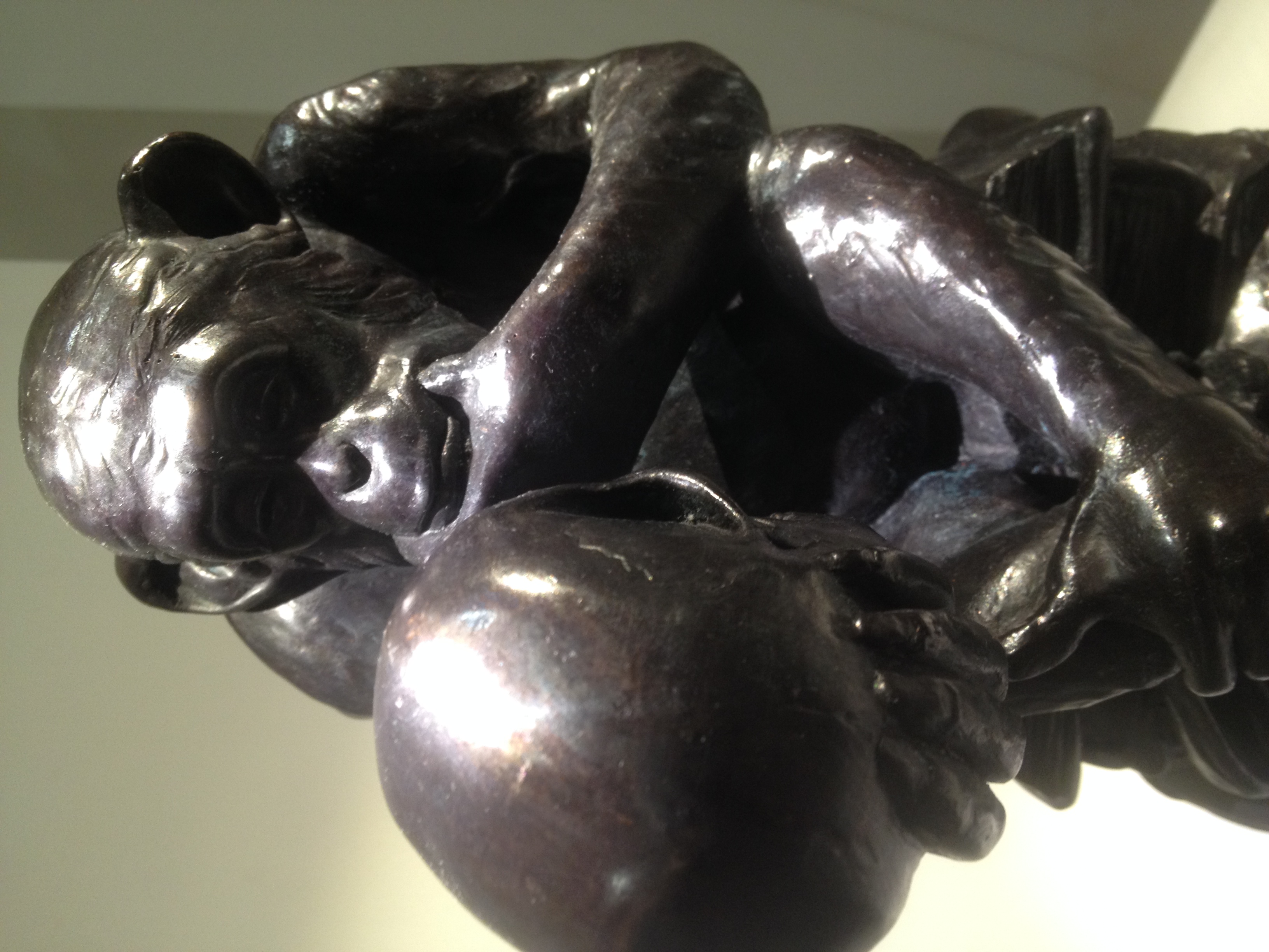 Close view of Rheinhold’s bronze chimpanzee contemplating the human skull