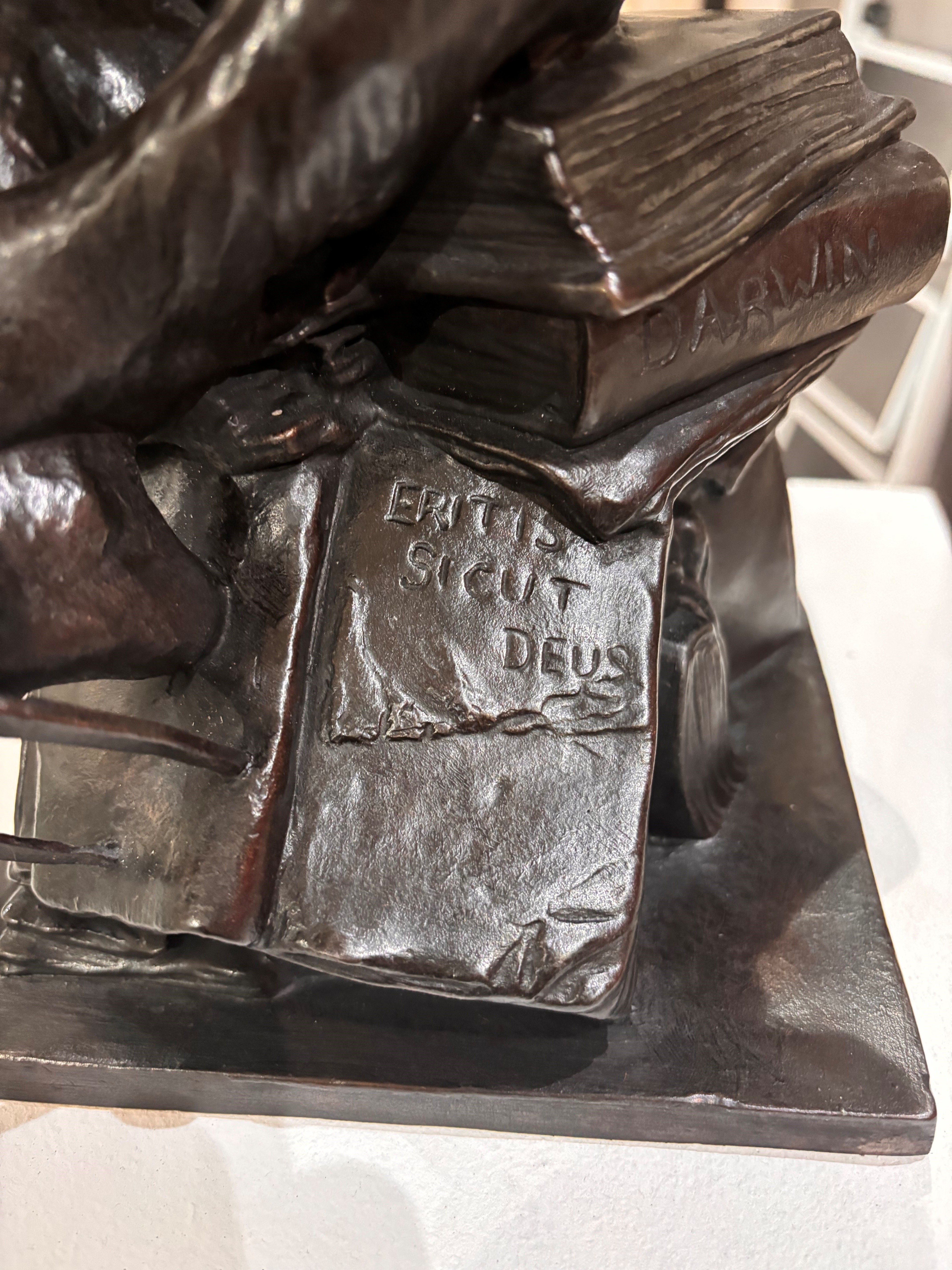Close-up of the book spine and inscription on the bronze sculpture