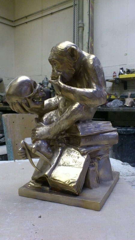Freshly cleaned golden bronze casting of Affe mit Schädel